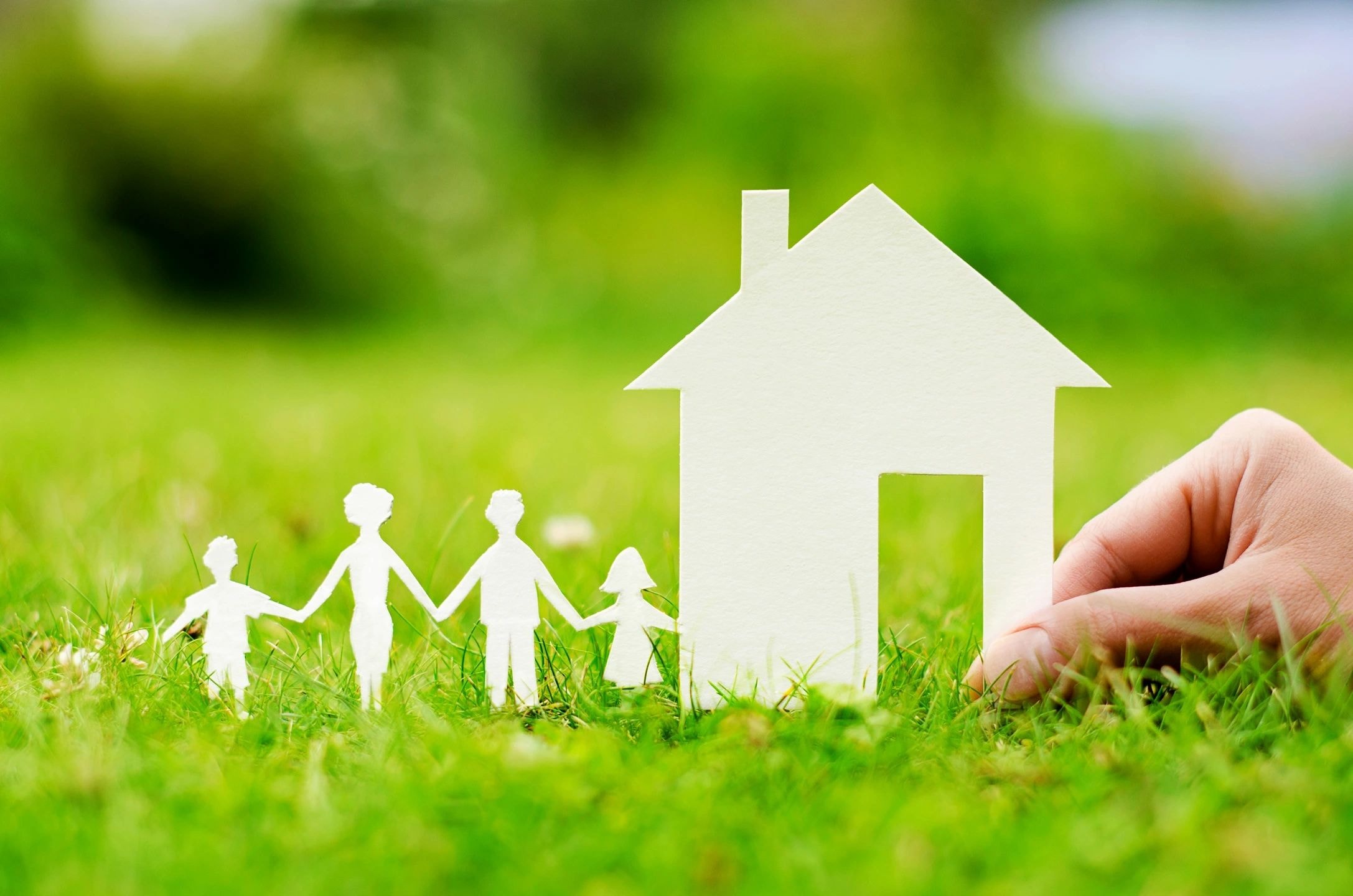 Family home paper cutout symbolising home protection